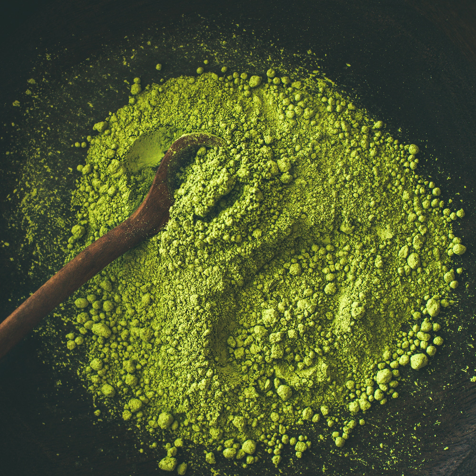 Japanese Matcha green tea powder in bowl, square crop